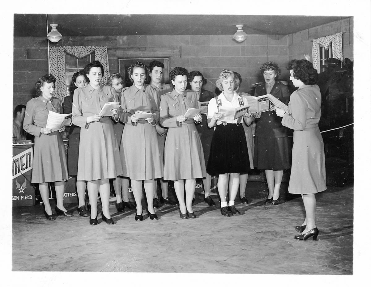 <p>Men weren't the only ones involved in the war effort. During World War II, women banded together to help in any way they could, including working in factories and as nurses. </p> <p>Here, some women are seen taking a little time off working. They are standing together and singing from a musical score.</p>