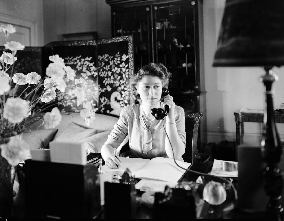 <p>Many people forget that Queen Elizabeth wasn't born as the Queen of England. Once upon a time, she was just the Princess. </p> <p>Even so, she did many royal duties around Buckingham, including answering phone calls and writing important notes and messages at her desk, as seen in the above picture. </p>