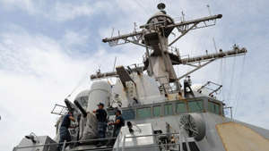 Navy sailors remove the cover of the Phalanx Close-In Weapon System of the USS Milius (DDG-69), a multi-mission capable guided missile destroyer ship docked at the Manila South Harbor on Aug. 18, 2012. NOEL CELIS/AFP/Getty Images