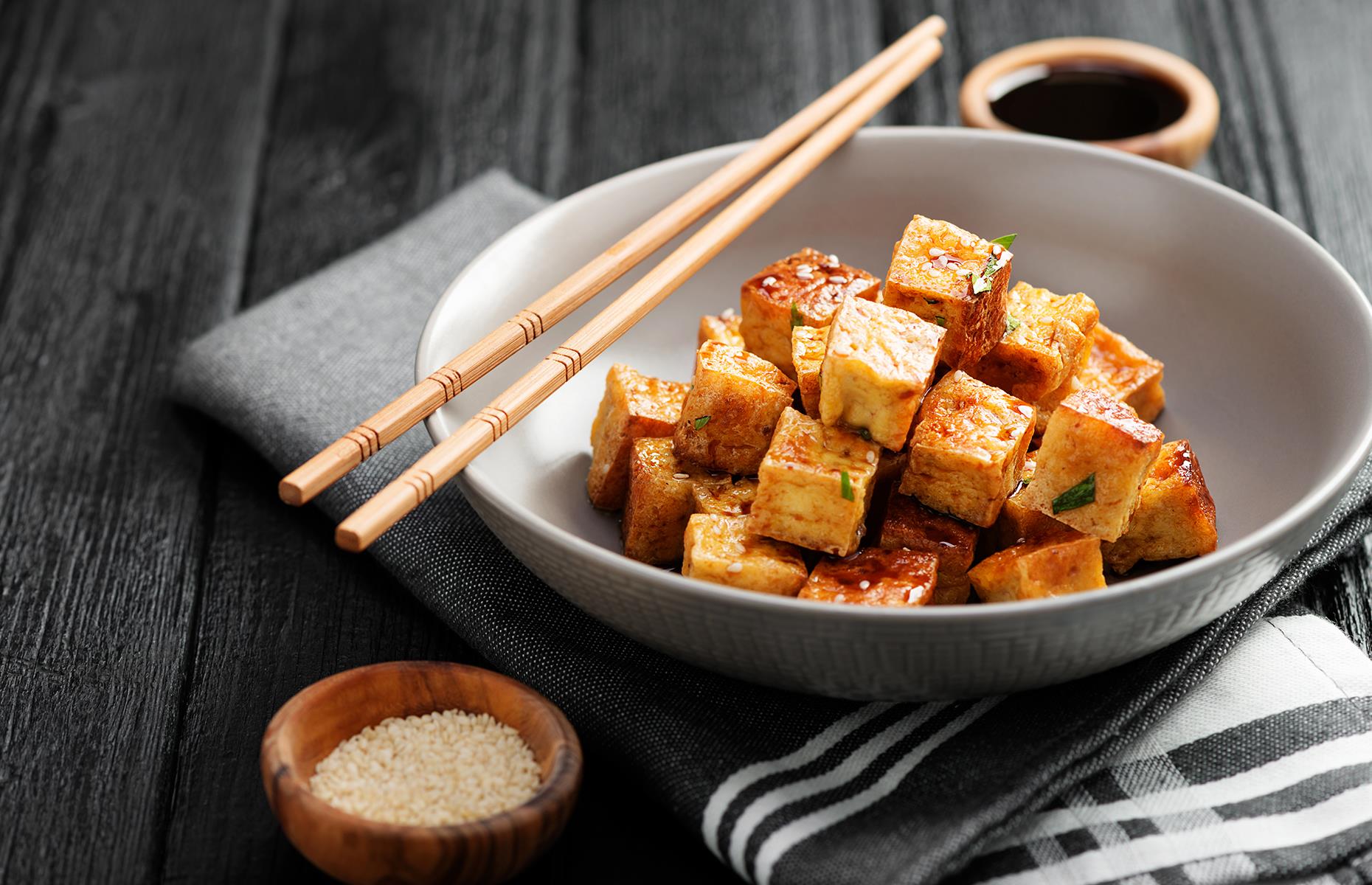 <p>In the UK and US, tofu was once eschewed as something for hippies and health-food nuts – but this versatile ingredient, made from soya milk curds, has soared in popularity in recent years. Many Asian cultures have long recognised its virtues though. Its exact origins are unclear but one story pins it to a Chinese cook who lived some 2,000 years ago – <a href="https://www.bbcgoodfood.com/howto/guide/ingredient-focus-tofu#:~:text=Like%20many%20soya%20foods%2C%20tofu,come%20into%20use%20until%201400.">legend has it</a>, the chef produced tofu when he accidentally curdled soya milk by adding seaweed to it.</p>