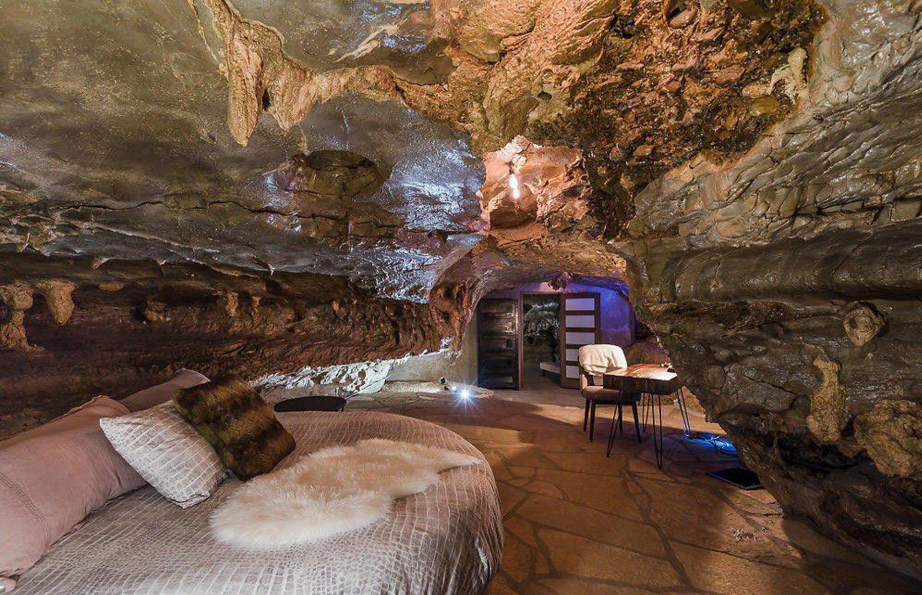 <p>Inside, the home boasts a unique natural aesthetic, with four bedrooms and four bathrooms. The cave can sleep up to 16 people at any one time, offering the ideal space for you and your family to hide out. With almost 6,000 square feet of interior space, you'll never feel overcrowded in this luxury abode.</p>
