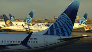 United Airlines airplanes parked at gates at Terminal C at Newark Liberty Airport as the sun sets on February 3, 2023, in Newark, New Jersey. Francisco Torres has been arrested and charged with allegedly attempting to open an emergency exit door and attacking a flight attendant with a broken metal spoon.