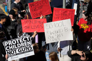 Students rally for gun control on March 23, 2023, outside the state Capitol in Denver. The 17-year-old suspect in a shooting that wounded two administrators at a Denver high school was found dead in a nearby county, authorities said.