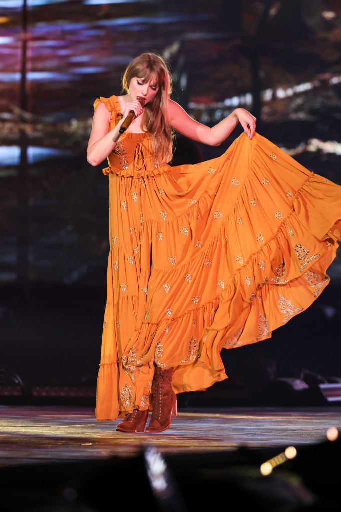 <p>Taking a turn, she wore a dreamy, country-style dress in bright orange from <a href="https://www.instagram.com/etro/?hl=en">Etro</a>.</p>