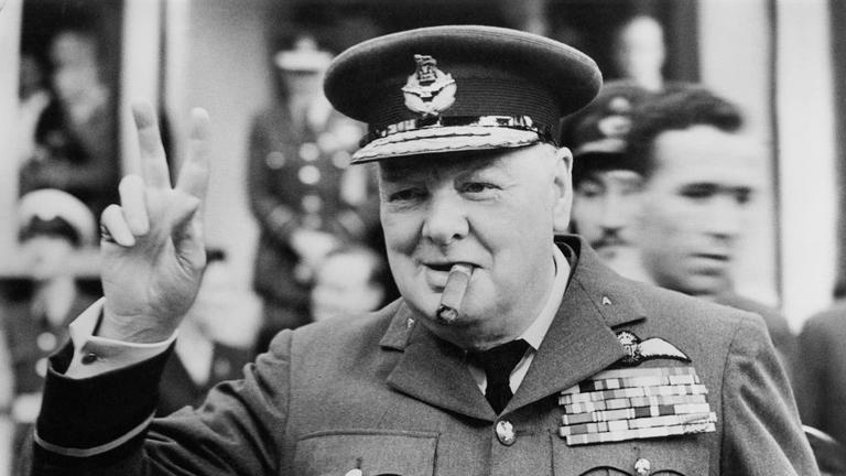 Winston Churchill (1874-1965) gives his famous v-sign as he opens the new headquarters of 615 (County of Surrey) Squadron of the RAAF (Royal Auxiliary Air Force) at Croydon, 1948. Getty Images