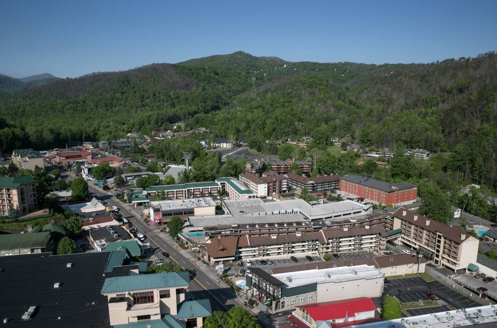 <p>In eastern Tennessee, there's a town called Gatlinburg that's snuggled right up against the 52,000-acre Great Smoky Mountains National Park. On their many miles of hiking trails, people can usually spot some bear cubs.</p> <p>A Gatlinburg sunset is something that should be seen in person and the city has many vantage points including the SkyLift Park, Space Needle, and Ober Gatlinburg's Aerial Tramway. Since it's in the South, there are plenty of mouth-watering food options including restaurants for barbecue, cider, and cookie dough.</p>