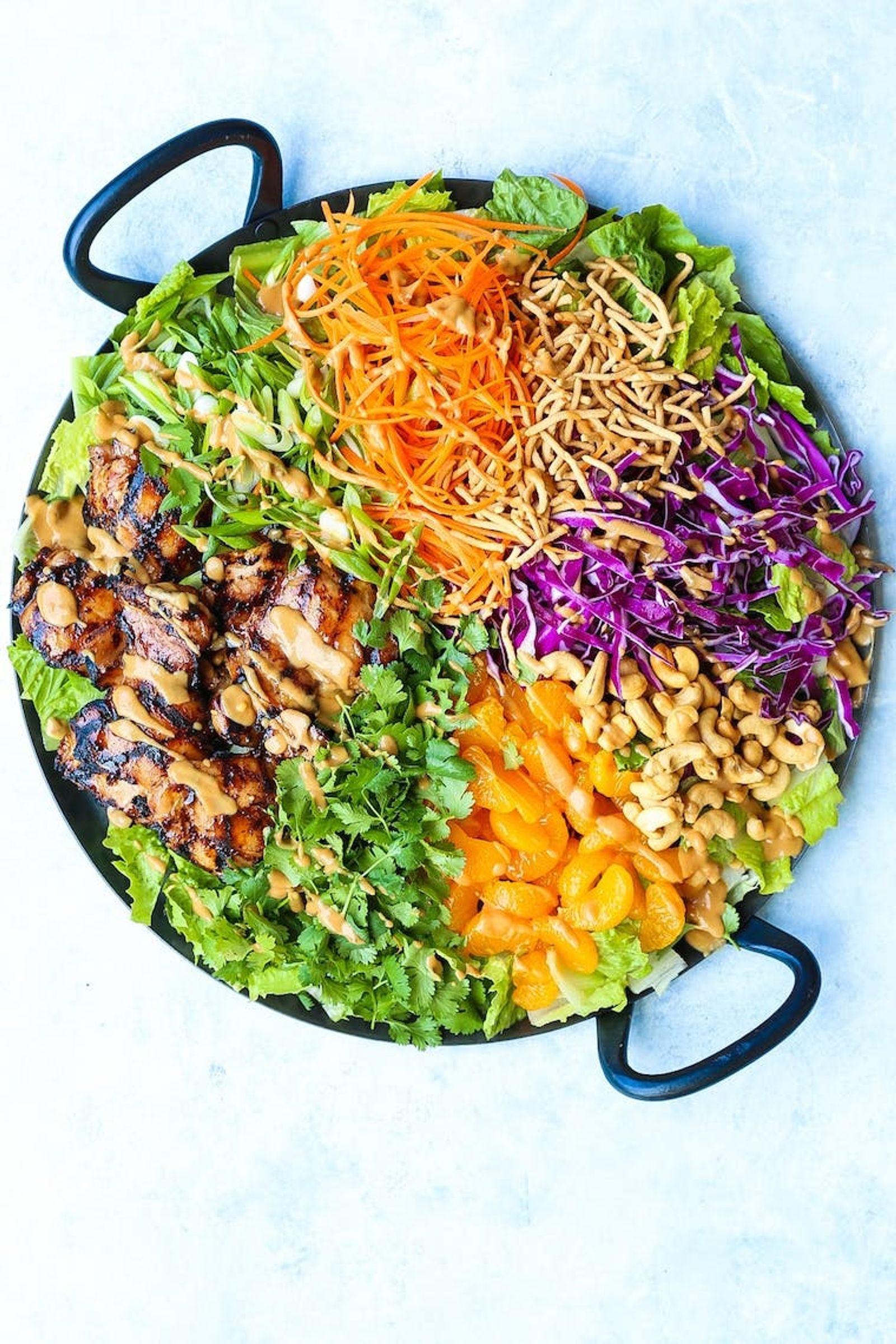 Use a store-bought rotisserie chicken for this salad, and you’ll have plenty of leftovers for the rest of the week. Switch up the fruits and veggies that you add on top – depending on your mood. The more colorful, the better! This is one veggie-packed easy lunch idea we can't get enough of. (via <strong><a href="https://damndelicious.net/2018/08/10/asian-chicken-salad/">Damn Delicious</a></strong>)