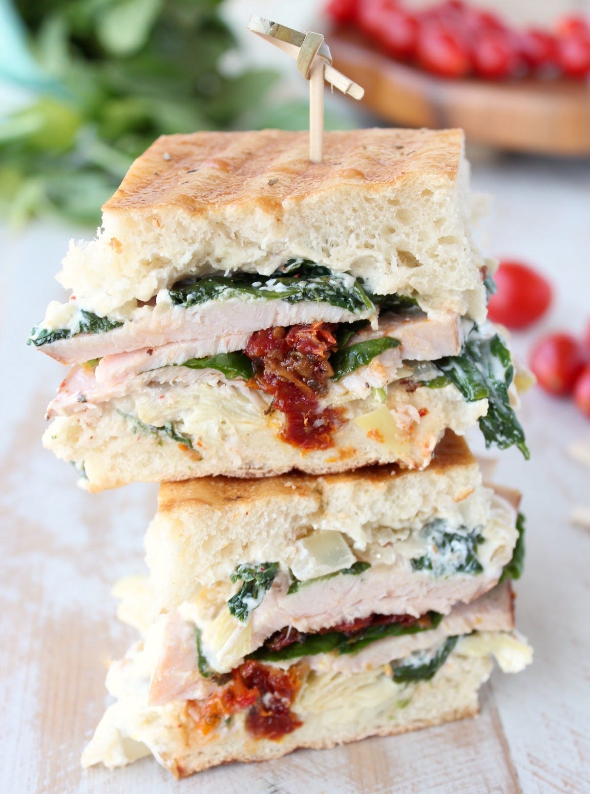This panini is packed with fresh turkey, spinach-artichoke dip, and sun-dried tomatoes. Buy pre-made dip and already sliced turkey, and lunch basically makes itself. (via <strong><a href="https://whitneybond.com/spinach-artichoke-turkey-panini/">Whitney Bond</a></strong>)