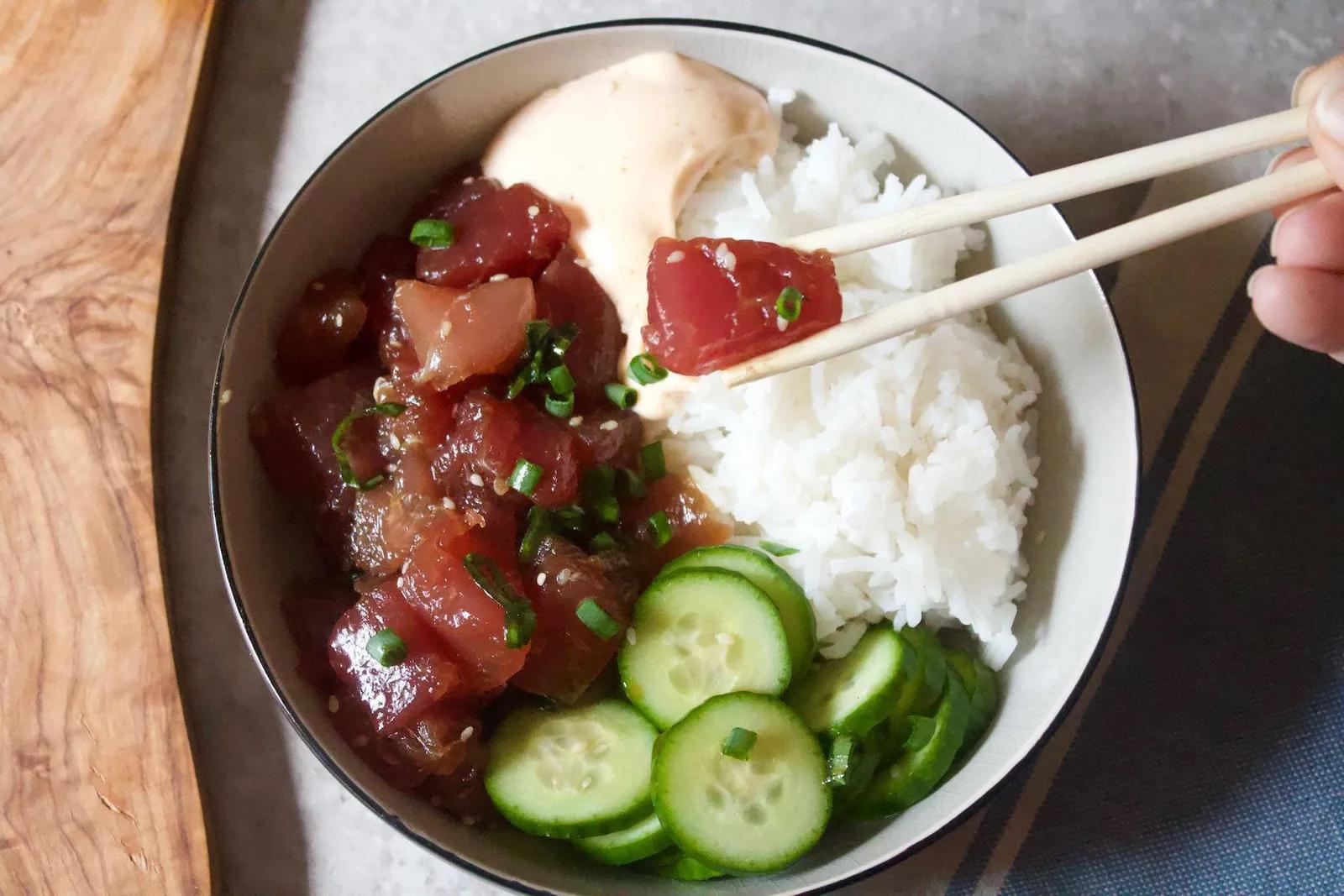 Perfect for leftover rice, this poke bowl just requires quickly mixing sushi-grade tuna in soy sauce, sesame oil, rice vinegar, slicing cucumbers, and topping it off with spicy mayo. (via <a href="https://www.brit.co/poke-bowl-recipe/"><strong>Brit + Co.</strong></a>)