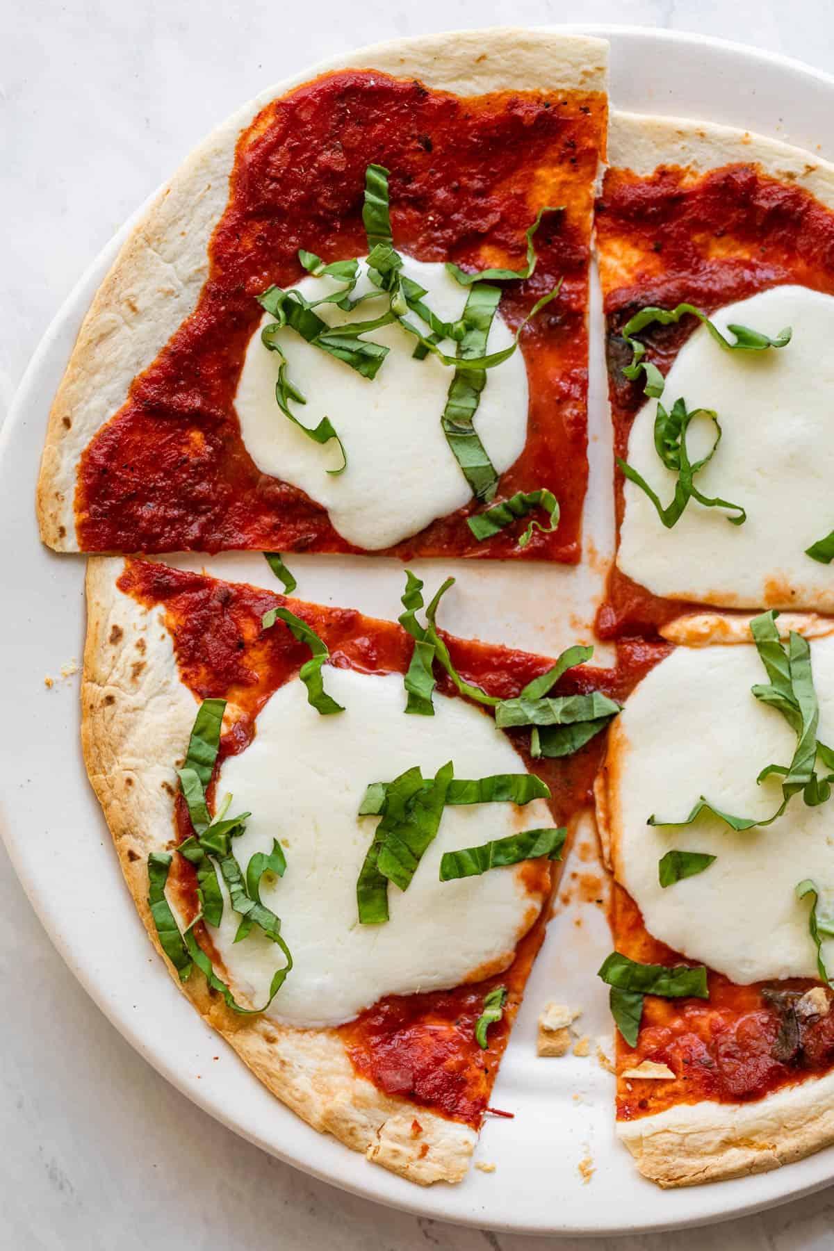 Get your pizza fix in 10 minutes with this tortilla take on pizza dough. (via <a href="https://feelgoodfoodie.net/recipe/tortilla-pizza/"><strong>Feel Good Foodie</strong></a>)