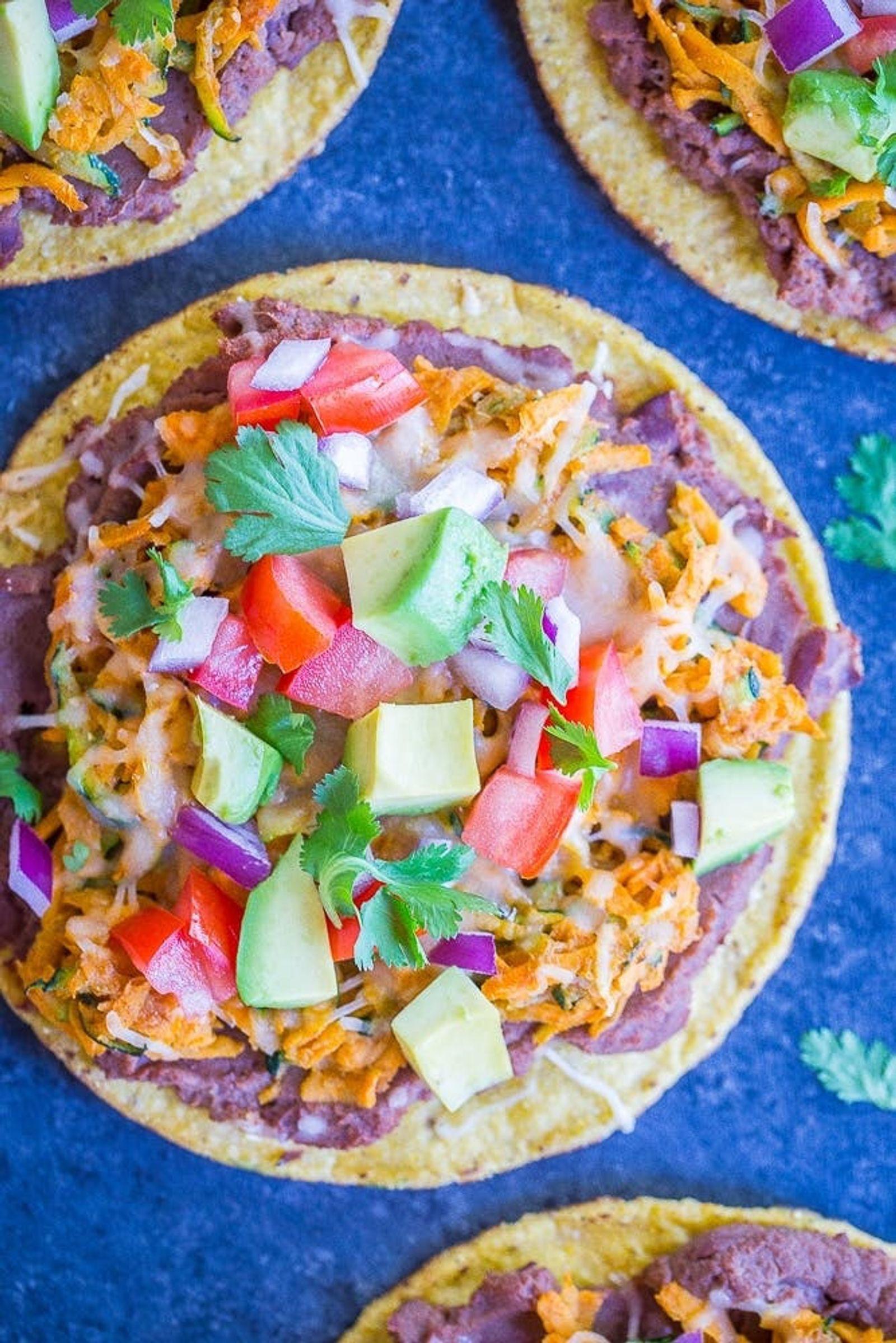 Make this mouthwatering lunch extra easily with store-bought tostadas, which you spread with refried beans (or black beans) and your choice of taco toppings, such as shredded sweet potato and grated cheese. (via <strong><a href="https://www.shelikesfood.com/sweet-potato-zucchini-tostadas/">She Likes Food</a></strong>)