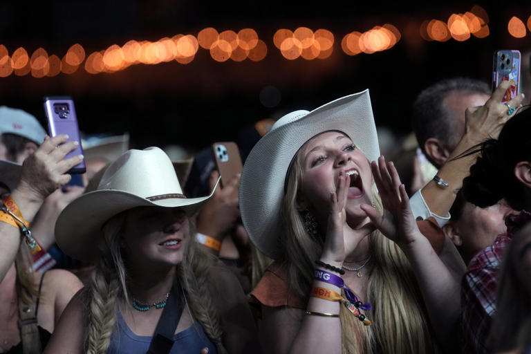 Fans cheer as Luke Bryan performs with his band at the Country Thunder Music Festival on April 14, 2023.