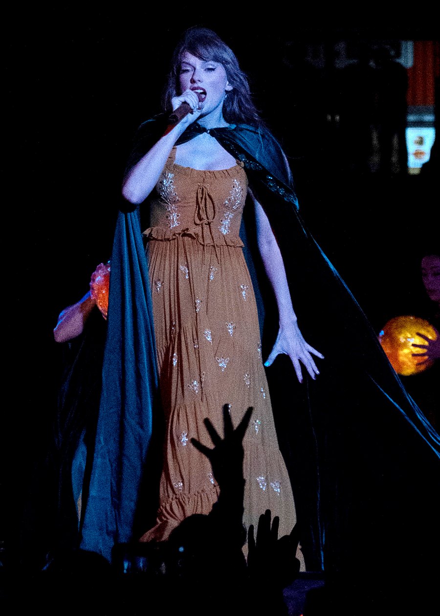 <p>Just like her “Willow” video, Swift sports a dark cape on her tour stage.</p>