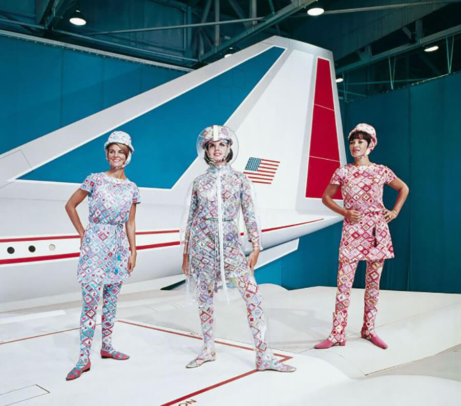 <p>If you thought the astronaut-inspired head gear was a bit out there, consider these outfits! Designed by elite fashion designer Emilio Pucci in 1966, stewardesses of Braniff International Airlines would wear these loudly patterned outfits with matching hats.</p> <p>Once other airlines saw the outfits that flight attendants of Braniff were wearing, they decided to contract designers of their own to remain competitive. Christian Lacroix designed uniforms for Air France, Vivienne Westwood was hired for Virgin Airlines, and designer Tracy Reese created the uniforms for United.</p>
