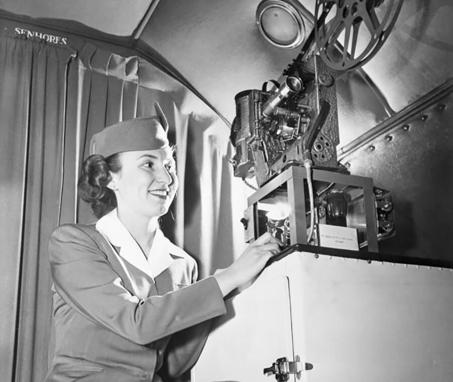 <p>Flight attendants had a wide range of duties in the '40s. One of those tasks included setting up the in-flight entertainment for passengers. Here, a Pan Am flight attendant is setting up the film reel to show a feature-length Hollywood film.</p> <p>Amazingly, in-flight entertainment began in the '20s, with comedies and newsreels. And by the '40s, passengers could enjoy an entire feature-length film. But imagine being held responsible for running and changing out the movie reels! There would be a lot of unhappy passengers if something went wrong.</p>