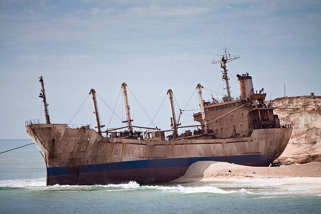 <p>The largest ship graveyard in the world can be found in Mauritania's Bay of Nouadhibou. Nouadhibou was originally a port settled by French merchants before World War I. As the popularity of iron mining in the area grew, lawlessness began to overtake it. </p> <p>Soon captains discovered that they could abandon their vessels for a simple bribe, instead of paying hefty fees and doing the grueling work associated with shipbreaking. In fact, people are still abandoning their ships there today. The most famous of the bay's ships is United Malika, a nearly 400-foot reefer vessel.</p>