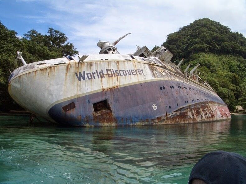 <p>Built in 1974, the MS World Discoverer was a cruise ship that would travel to the Antarctic polar regions so that passengers could observe ice floe movements. Then in 2000, bad weather caused the ship to hit a reef off the Solomon Islands in the Pacific Ocean.</p> <p>After all of the passengers were rescued by a ferry, the captain grounded the ship on Roderick Bay. The ship was then looted by locals and soon declared unsalvageable. It still remains, lying on its side, half-submerged, not yet too damaged by decay.</p>