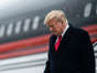 Former President Donald Trump disembarks his plane as he lands at Quad City International Airport in route to Iowa on Monday in Moline, IL. (Photo by Jabin Botsford/The Washington Post)