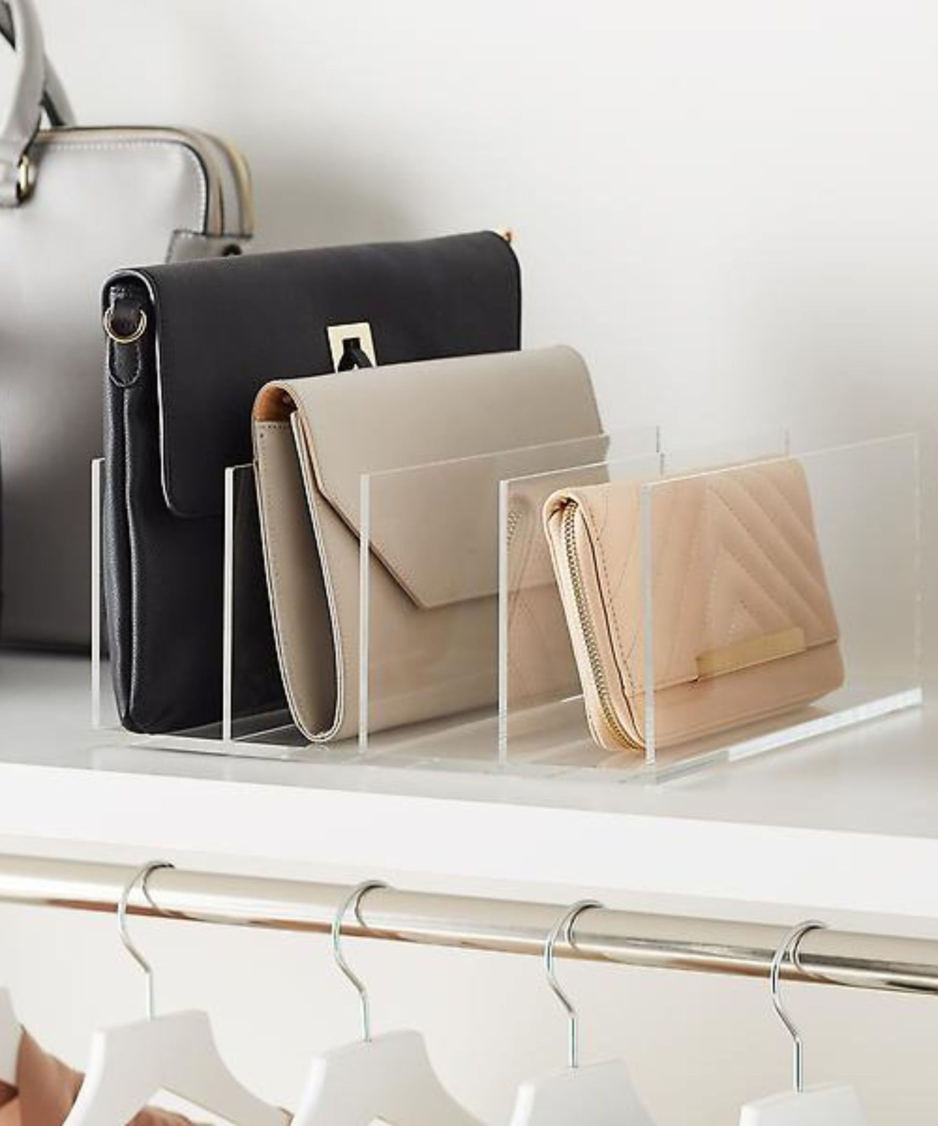 <p>                     ‘For clutches and small purses, using an acrylic organizer such as this Container Store option [pictured] on a shelf in your closet will allow you to easily corral your bags,’ explains Lauren Saltman. ‘If you have more than what fits in one, just add a second one side-by-side. Grouping the purses by color will help you to quickly find what you are looking for.’                   </p>                                      <p>                     What's more, organizers like these can be used to help store a range of closet accessories, be it folded jumpers and sweaters, or turn it on its side to help separate folded trousers and leggings.                     </p>                                      <p>                     ‘For large purses, I recommend stuffing them with acid-free paper or customized purse pillows’ Lauren Saltman, professional organizer, recommends. ‘This will help prevent unnecessary creasing due to long-term storage. If your closet has the space, displaying your stuffed purses on an upper shelf can be a very pleasant way to decorate your closet when the bags are not in use too.’                    </p>