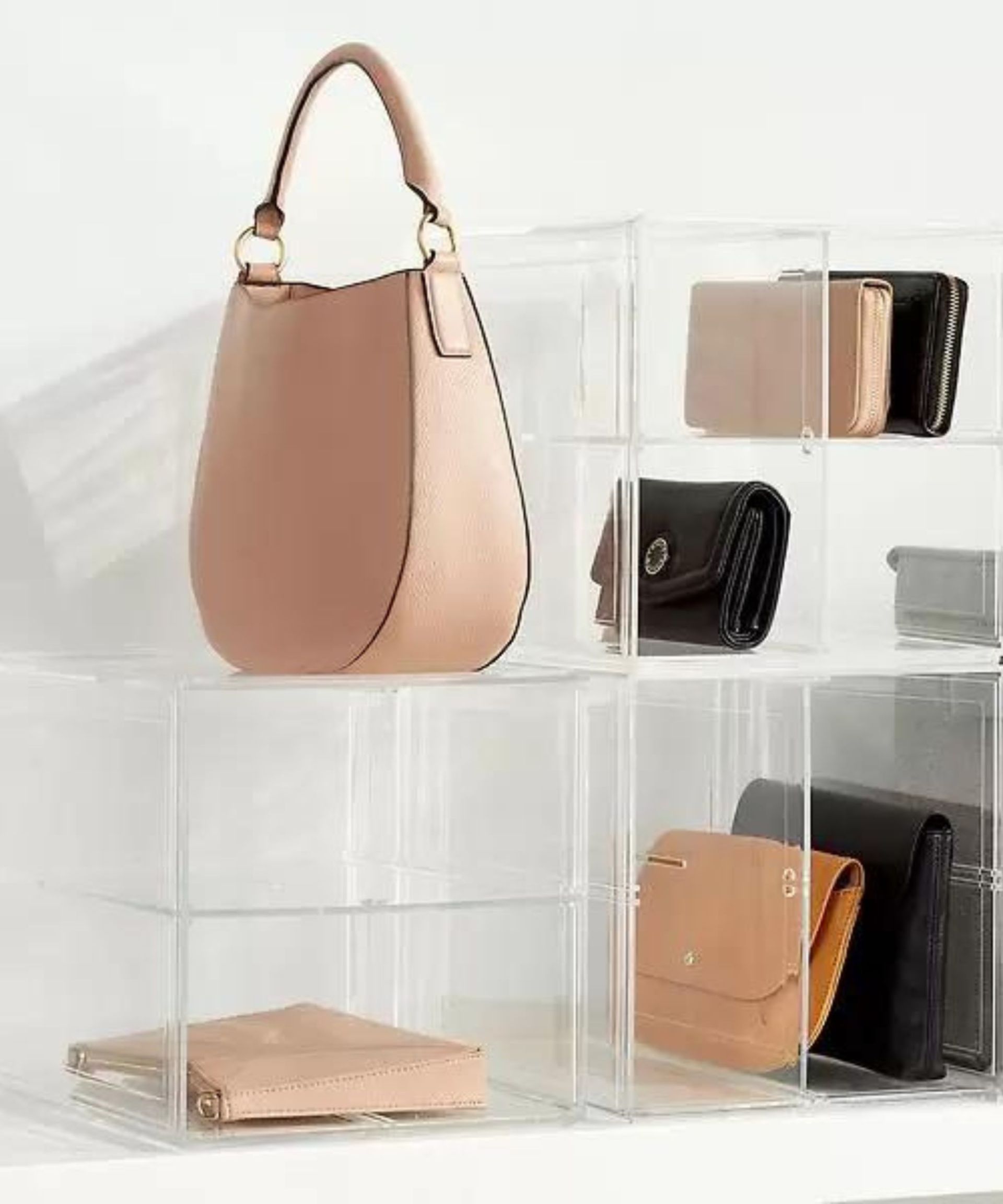 <p>                     One of the best parts about a purse is how pretty they look even when not in use. While we often like to hide our closet contents away to prevent visual clutter, you may want to keep your purses in pride of place. Using a cube divider like this one pictured from The Container Store can help to add height to your purses and display them in levels for visual interest.                     </p>