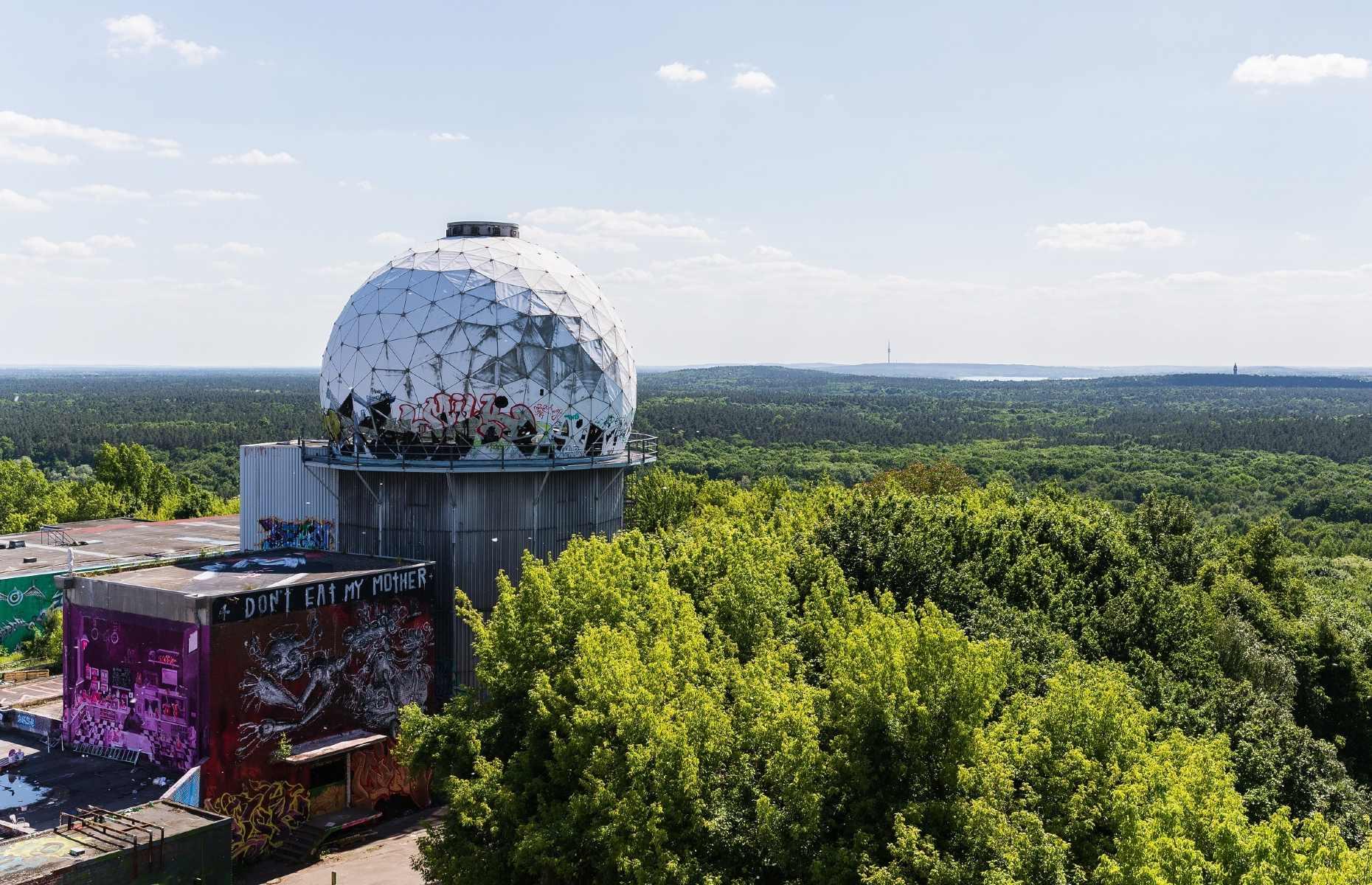 <p>A Cold War relic and former radio tower, <a href="https://www.teufelsberg-berlin.de/en/">Teufelsberg</a> stands at what used to be the highest point in West Berlin, atop a manmade hill forged of debris from the Second World War (Teufelsberg means ‘Devil’s Mountain’ in English). From here, the United States’ National Security Agency would spy on the Soviet Union, intercepting satellite transmissions and communication channels. These days it remains an ominous spectacle, but is much more welcoming – a popular sunset-gazing spot, with its own panoramic terrace and street art gallery.</p>