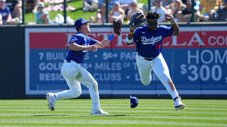 Feb 23, 2025; Phoenix, Arizona, USA; Los Angeles Dodgers outfielder Tommy Edman (25) makes a catch on a pop-up while avoiding teammate right fielder Zyhir Hope (94) during the third inning at Camelback Ranch-Glendale. Mandatory Credit: Joe Camporeale-Imagn Images | Joe Camporeale-Imagn Images