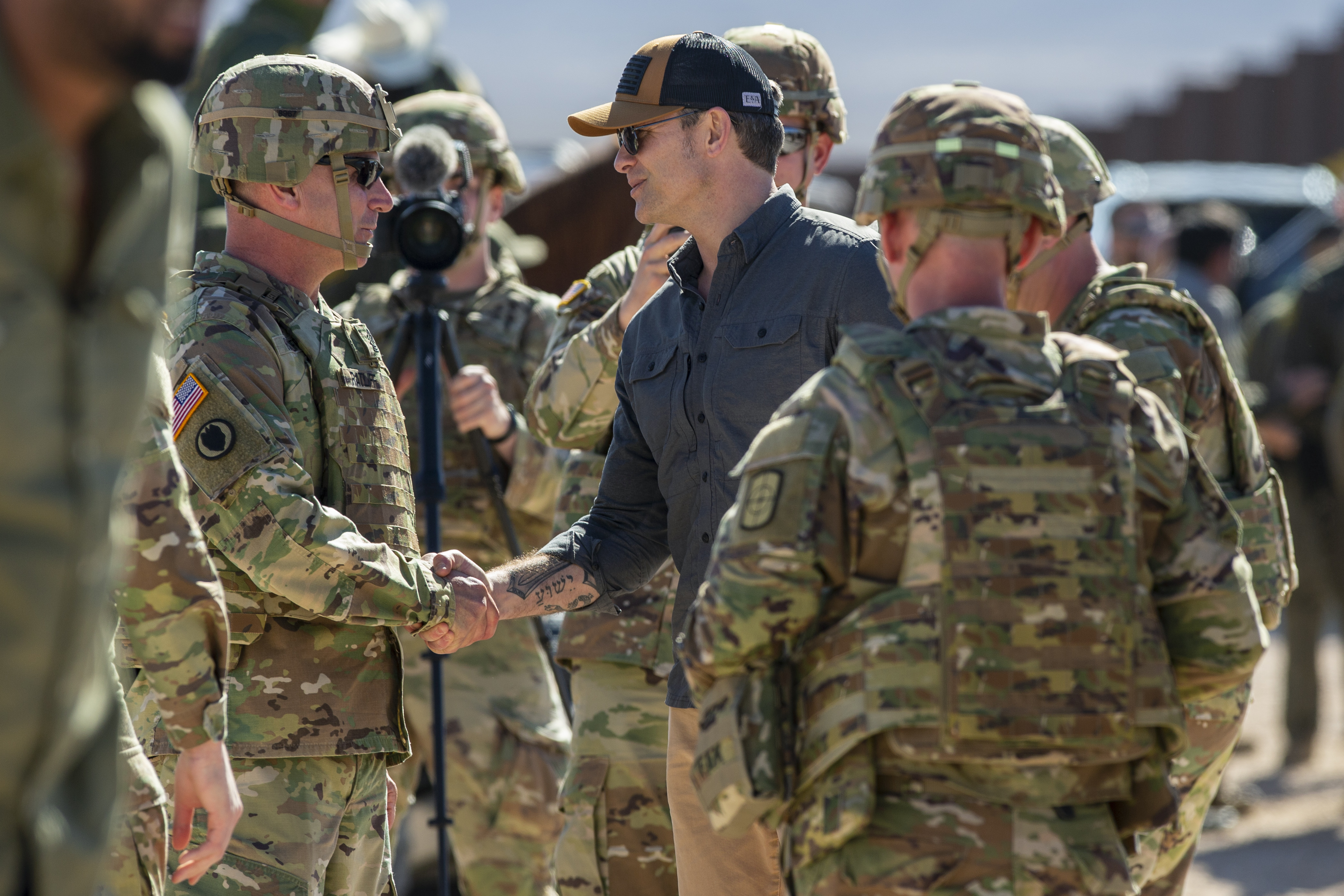 Defense Secretary Pete Hegseth, center, is greeted by Army soldiers while visiting the U.S.-Mexico border in Sunland Park, New Mexico, Feb. 3, 2025.