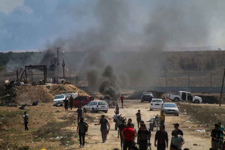 Smoke billowed near the border fence between the Gaza Strip and Israel on Oct. 7, 2023.