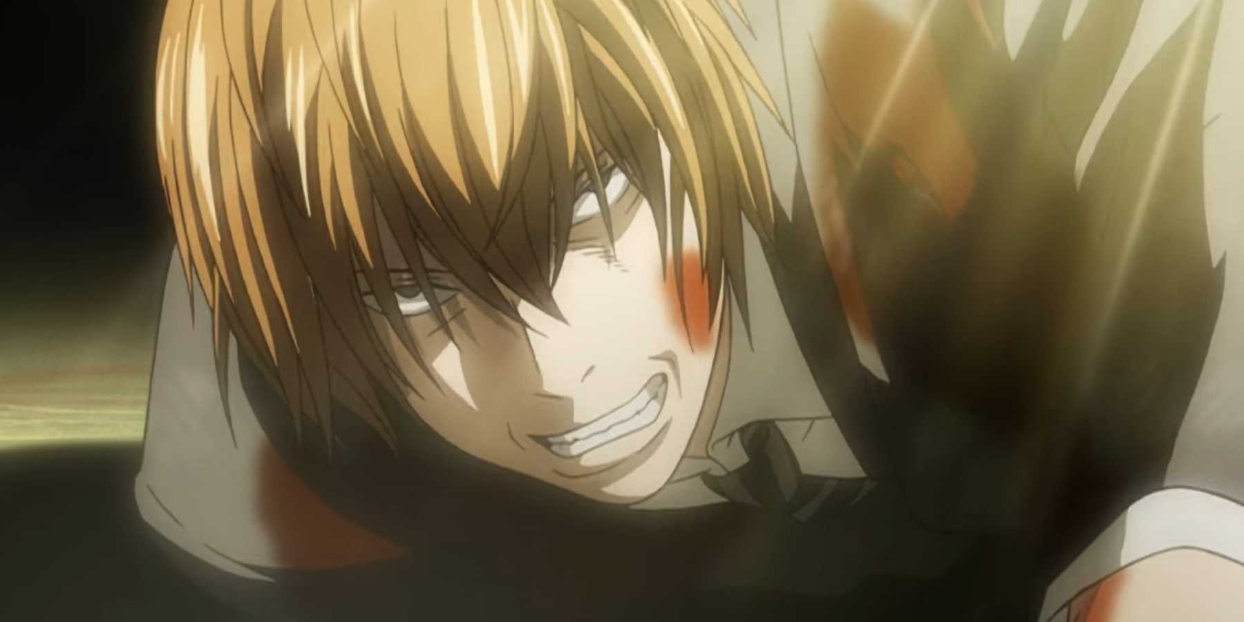 Light Yagami is injured on the floor in Death Note.