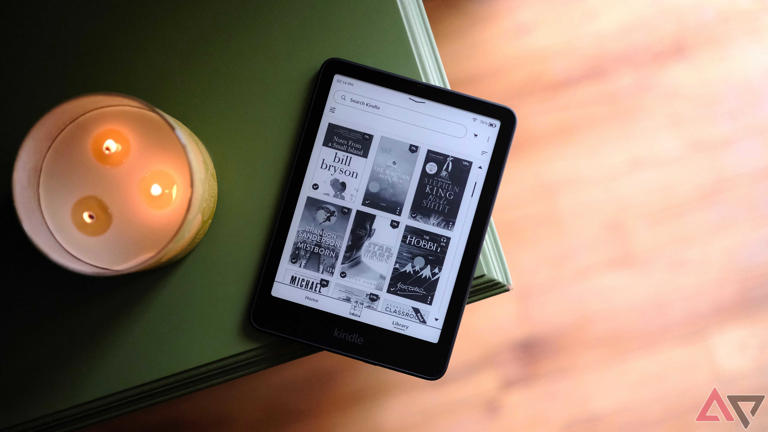 A Kindle Paperwhite sitting on the edge of a table