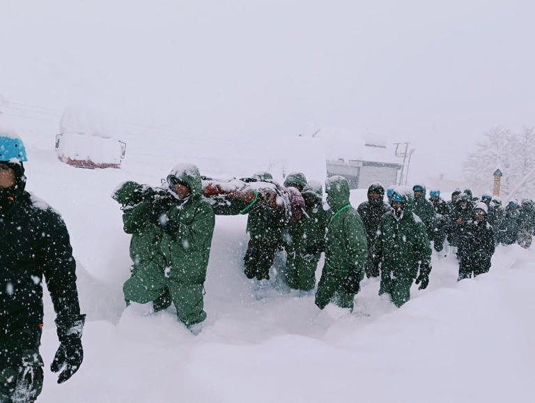 Dozens found alive inside metal containers after they were buried by ...