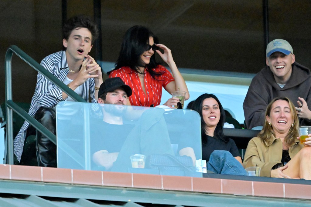 For the sporty outing, Jenner wore a red crop top and tan trousers while Chalamet opted for a striped button up shirt and leather pants. IMAGN IMAGES via Reuters Connect