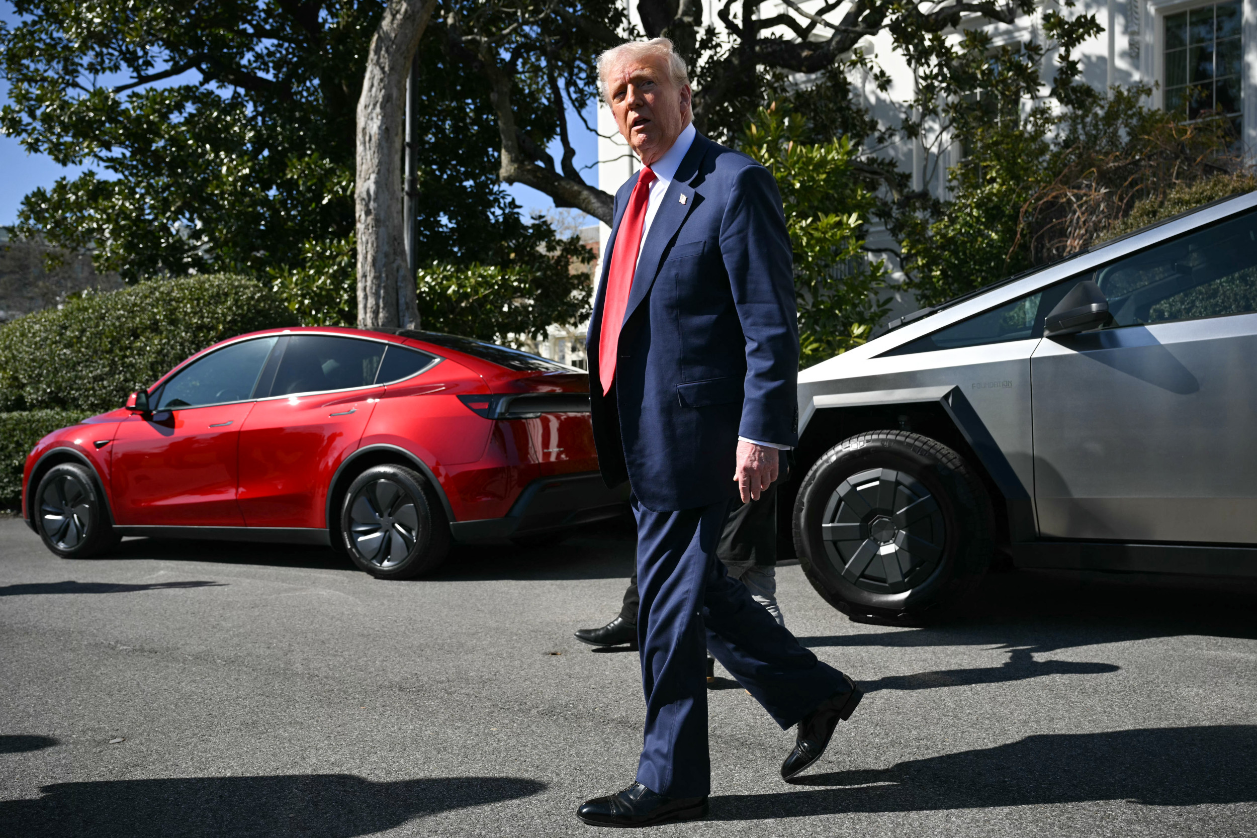 President Donald Trump is seen leaving after speaking to the press next to Tesla vehicles at the White House on March 11, 2025. MANDEL NGAN/AFP via Getty Images