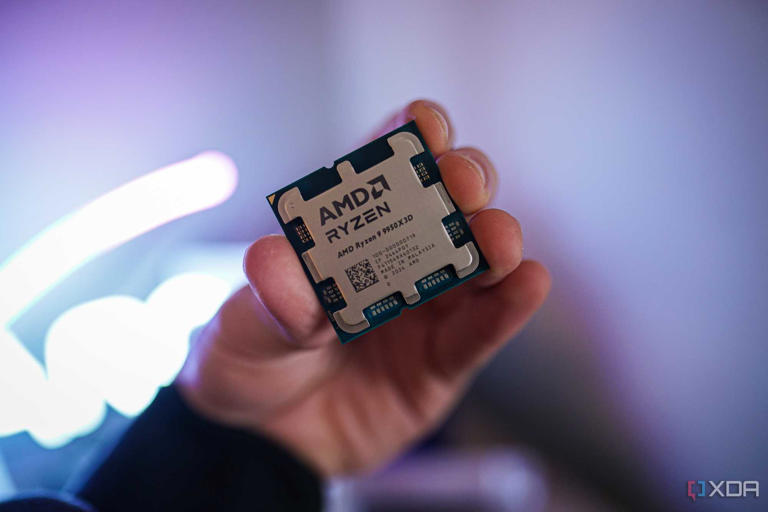 A hand holding the Ryzen 9 9950X3D. 