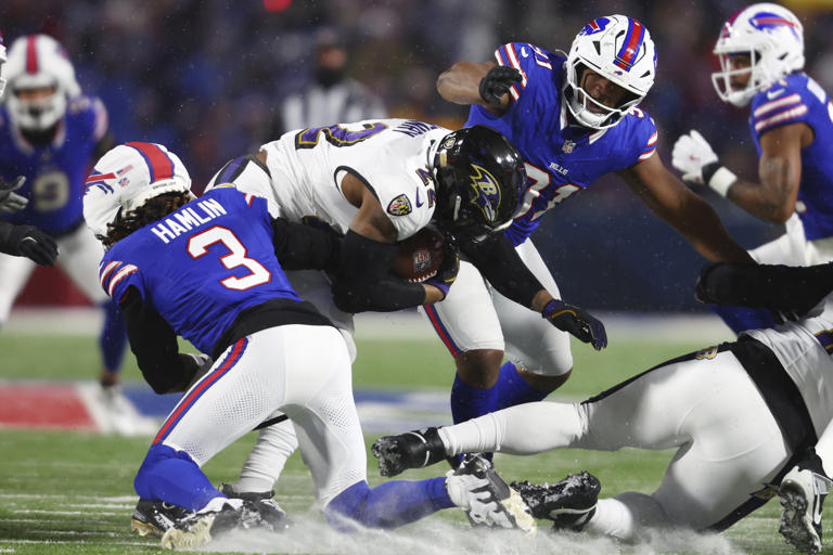 FILE - Baltimore Ravens running back Derrick Henry (22) is brought down by Buffalo Bills safety Damar Hamlin (3) during the first half of an NFL football divisional playoff game in Orchard Park, N.Y., Jan. 19, 2025. (AP Photo/ Jeffrey T. Barnes, file)