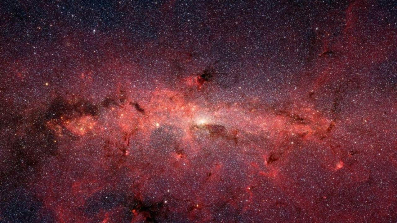 Galactic cores, such as the Milky Way’s center in this image, are packed with gas and debris, making it difficult to capture clear images of stars or black holes. (Image: NASA)