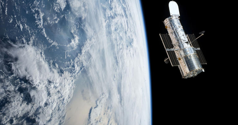 Hubble Space Telescope orbiting planet Earth. Photo: Shutterstock.com