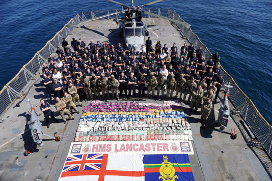 The crew of the HMS Lancaster with the haul of drugs (Lt Nathan Boal/PA Wire)