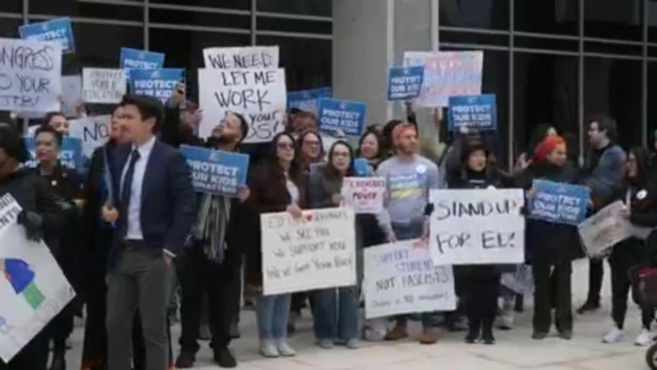 Protestors gather outside of Department of Education following recent
