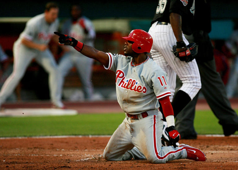 Jimmy Rollins of the Philadelphia Phillies points to teammates after hitting an inside-the-park home run against the Florida Marlins at Dolphin Stadium on April 7, 2007.