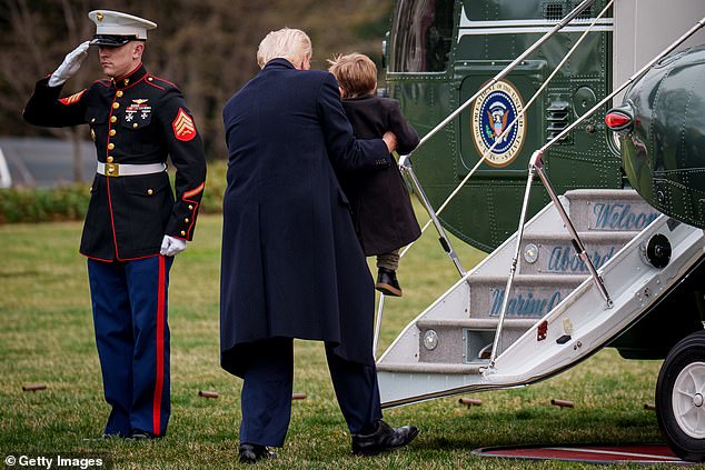 President Donald Trump helps Ã¿ A-Xii, the son of White House Senior Advisor, Tesla and SpaceX CEO Elon Musk, up the stairs of Marine One on the South Lawn
