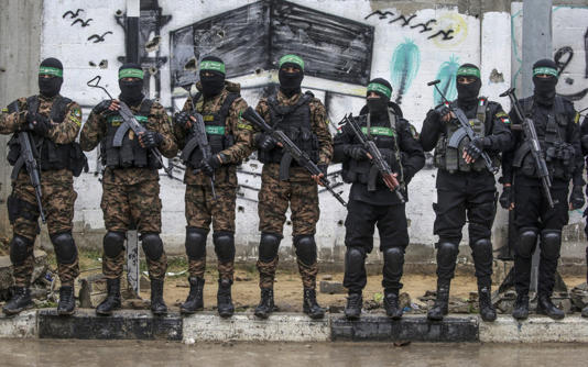 Hamas militants stand guard in Al Nuseirat refugee camp in central Gaza - MOHAMMED SABER/EPA-EFE/Shutterstock