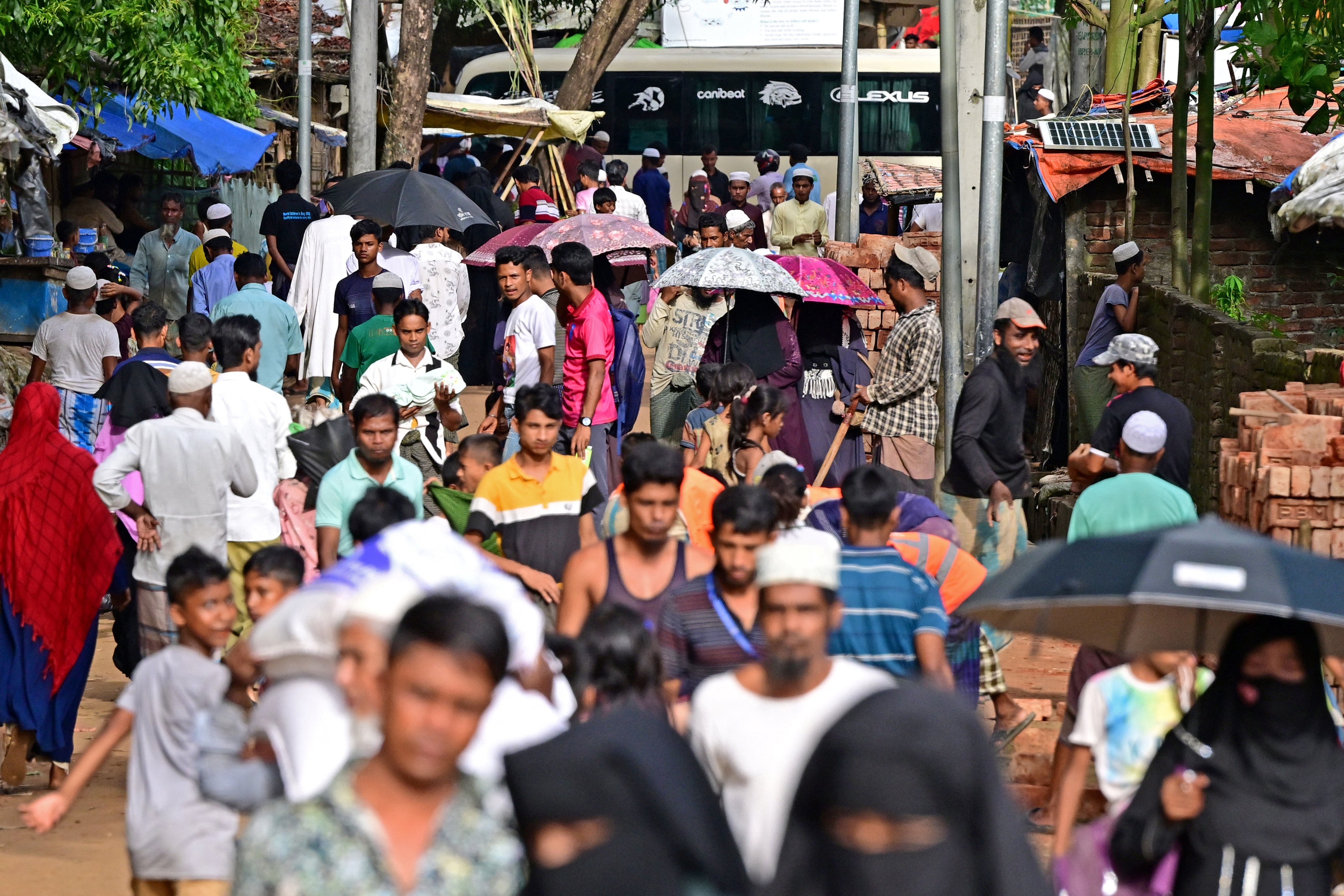 Rohingya refugees walk through a camp in Ukhia. Around a million members of the stateless and persecuted Muslim minority live in a sprawling patchwork of Bangladeshi relief camps after fleeing violence in their homeland next door. (AFP via Getty Images)