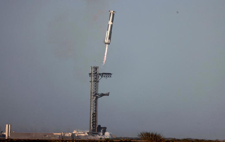 The Super Heavy booster returns to its launch pad after the SpaceX Starship spacecraft continued to space following its launch on its eighth test at the company's Boca Chica launch pad in Brownsville, Texas, March 6, 2025.