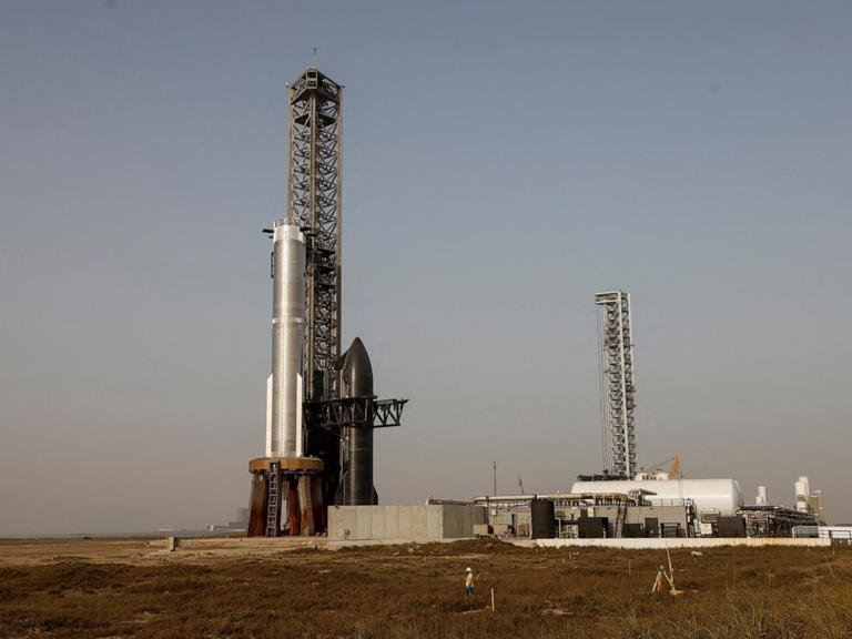 SpaceX's next-generation Starship spacecraft, right of tower, is shown with the Super Heavy booster after a delay of its eighth test at the company's Boca Chica launch pad in Brownsville, Texas, March 5, 2025.