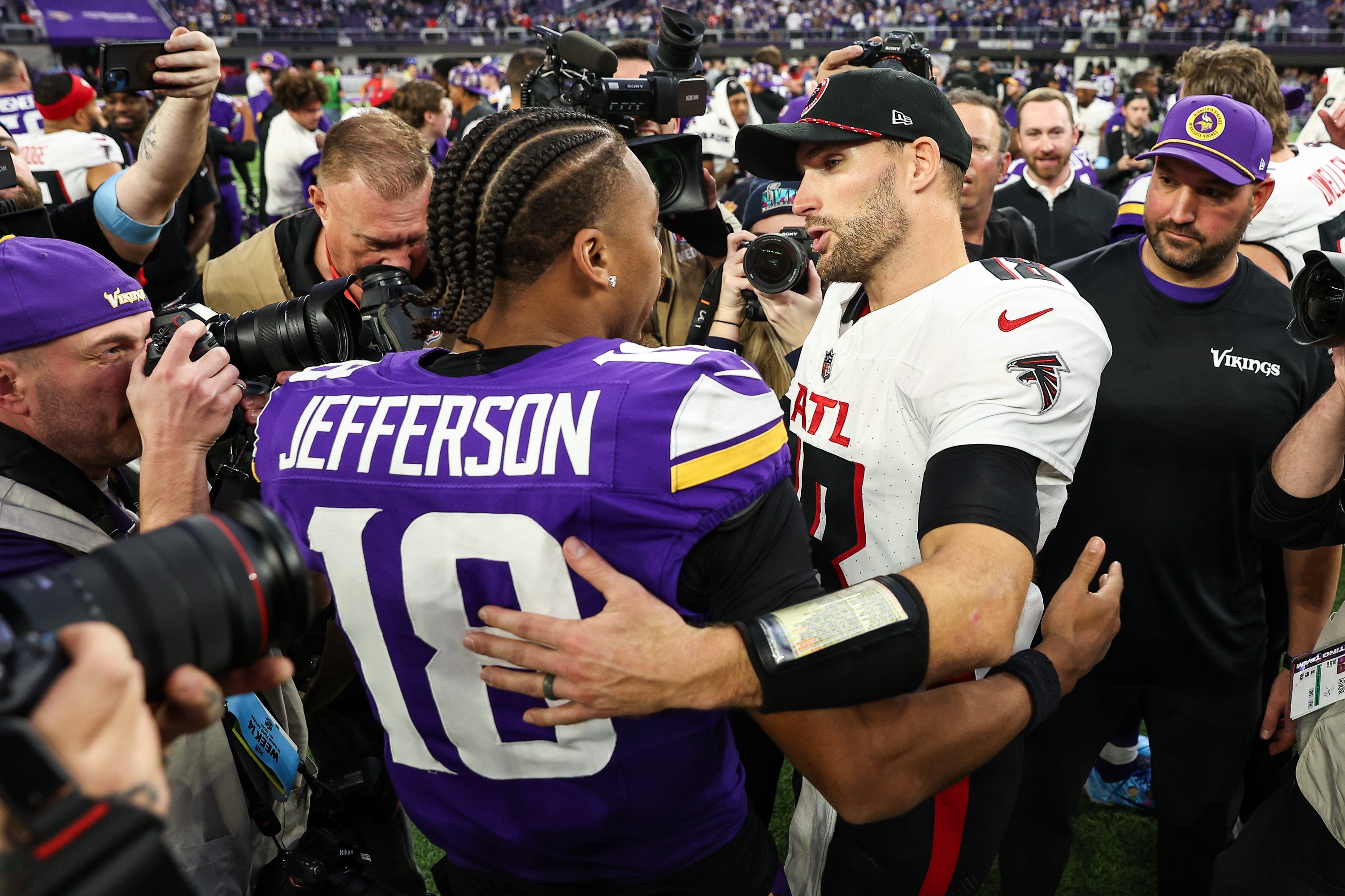 Dec 8, 2024; Minneapolis, Minnesota, USA; Minnesota Vikings wide receiver Justin Jefferson (18) and Atlanta Falcons quarterback Kirk Cousins (18) talk after the game at U.S. Bank Stadium. Mandatory Credit: Matt Krohn-Imagn Images