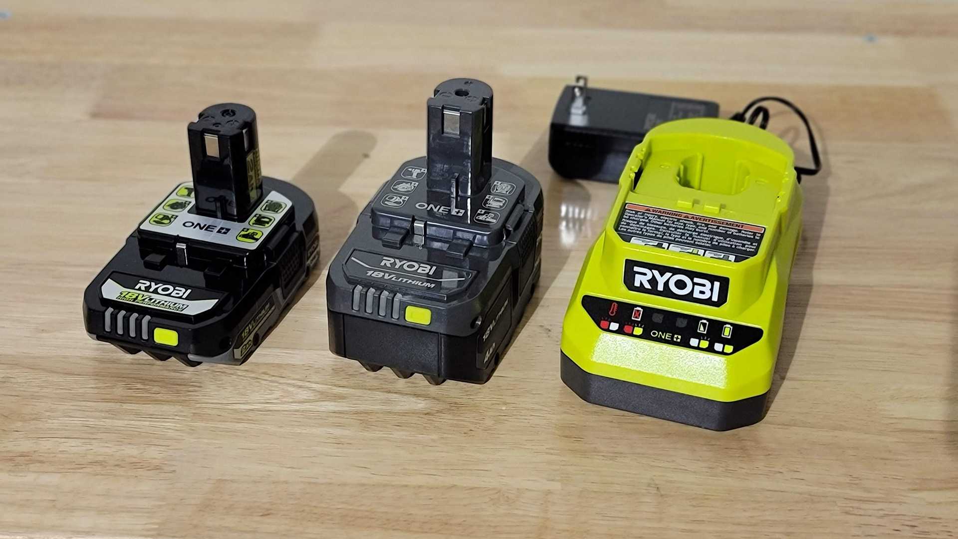 Ryobi battery and charger on a work bench.