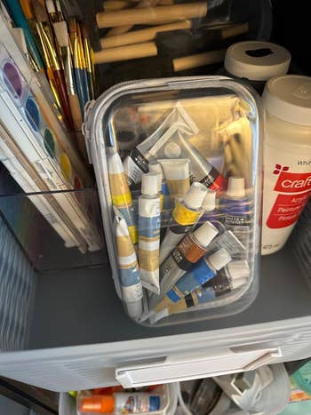 Art supplies, including paint tubes in a plastic case