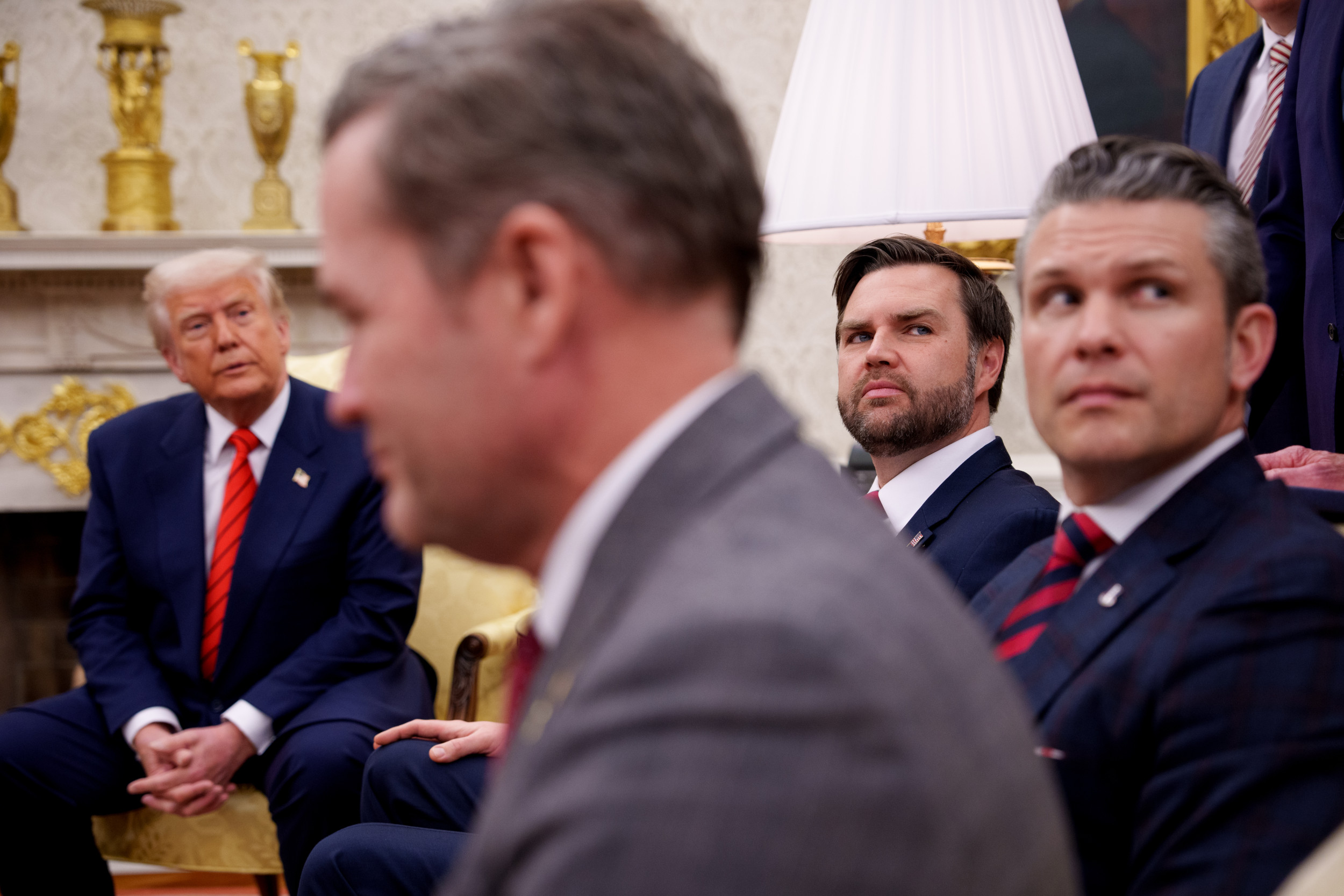 President Donald Trump is seen alongside U.S. National Security Adviser Michael Waltz, U.S. Vice President J.D. Vance, and Defense Secretary Pete Hegseth, listening to a question from a reporter during a meeting in the Oval Office of the White House on March 13, 2025, in Washington, D.C. (Photo by Andrew Harnik/Getty Images)