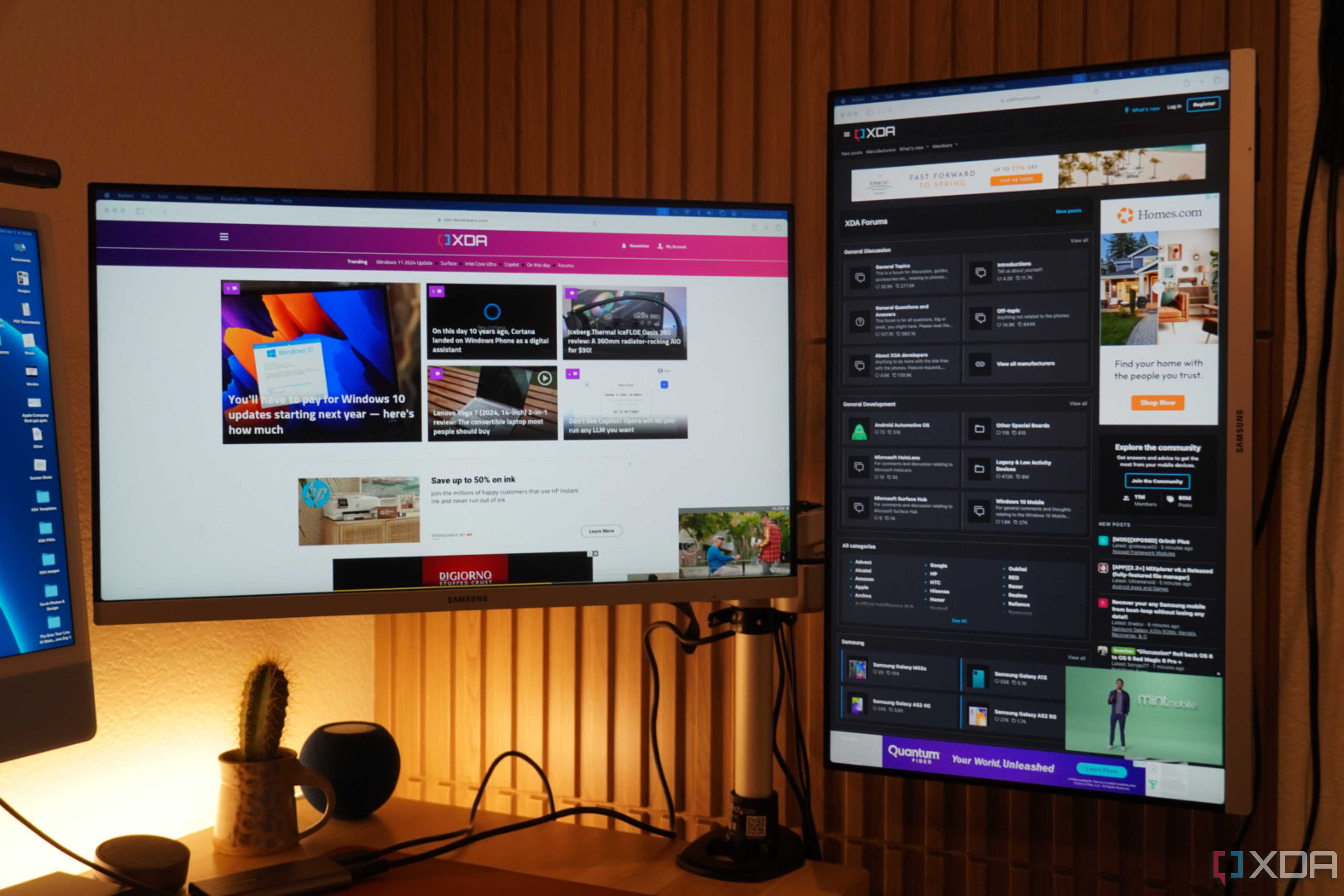 The XDA homepage and forums on monitors on a StarTech mount.